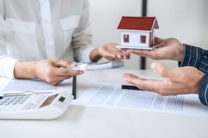 Real estate broker agent consult to customer to decision making sign insurance form and sending house model to client after approve, home model mortgage loan offer for and house insurance.